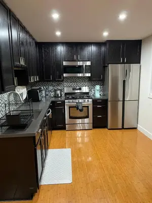 a kitchen with black cabinets and stainless steel appliances at Stunning, Quiet Vista Retreat Minutes from Beach in Vista