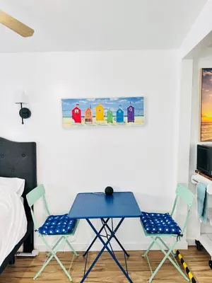 a bedroom with a blue table and two chairs at Cozy Guesthouse - 15 Min to Downtown SD in Chula Vista
