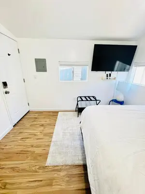 a bedroom with a bed and a flat screen tv at Cozy Guesthouse - 15 Min to Downtown SD in Chula Vista