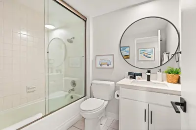 a bathroom with a toilet and a sink and a mirror at Seize the Day in San Diego