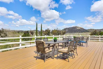a wooden deck with a table and chairs on it at Near Ramona Wineries Mtn-View Haven with Large Yard in Ramona
