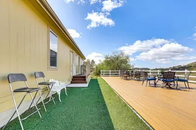 a deck with chairs and tables on a house at Near Ramona Wineries Mtn-View Haven with Large Yard in Ramona