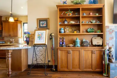 a kitchen with a large wooden book shelf at Pool Hot Tubs Views - Castillo de Windsor in San Diego