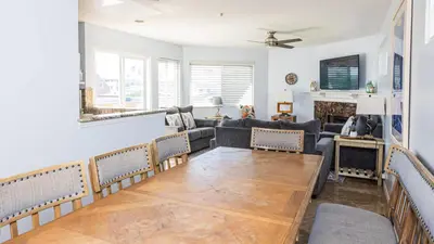 a living room with a couch and a table at Balboa Escape An Iconic Stay in Newport Beach
