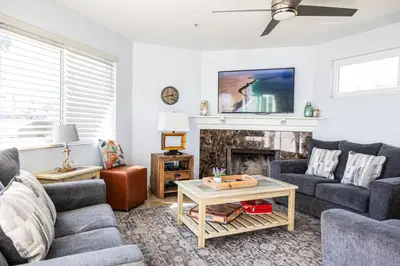 a living room with two couches and a fireplace at Balboa Escape An Iconic Stay in Newport Beach