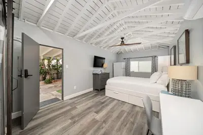 a bedroom with a bed and a tv in it at Bayside Getaway Waterfront in Newport Beach
