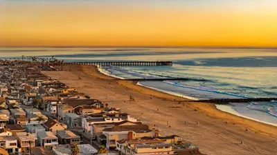 an aerial view of a beach with a pier at Bayside Getaway Waterfront in Newport Beach