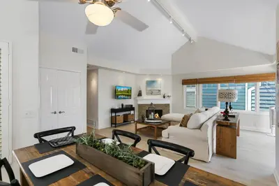 a dining room and living room with a table and chairs at SoCal's Finest Gem on Dahlia in Corona del Mar