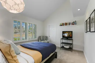 a bedroom with a bed and a tv in it at SoCal's Finest Gem on Dahlia in Corona del Mar