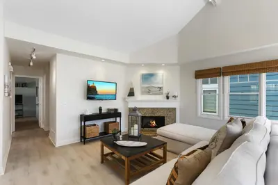 a living room with a white couch and a fireplace at SoCal's Finest Gem on Dahlia in Corona del Mar