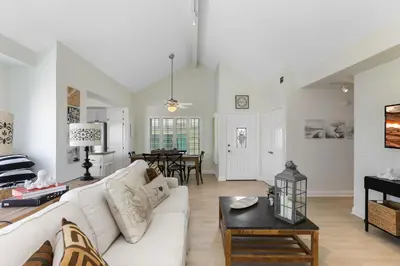 a living room with a white couch and a table at SoCal's Finest Gem on Dahlia in Corona del Mar