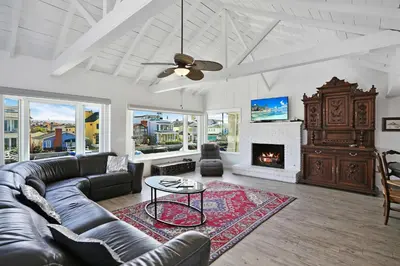 a living room with a couch and a fireplace at Grand Canal Getaway - Balboa Island in Newport Beach