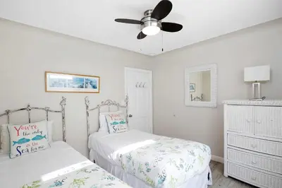 a bedroom with two beds and a ceiling fan at Grand Canal Getaway - Balboa Island in Newport Beach