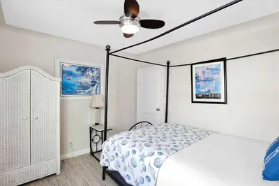a bedroom with a bed and a ceiling fan at Grand Canal Getaway - Balboa Island in Newport Beach