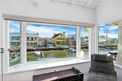a room with a window with a view of a harbor at Grand Canal Getaway - Balboa Island in Newport Beach