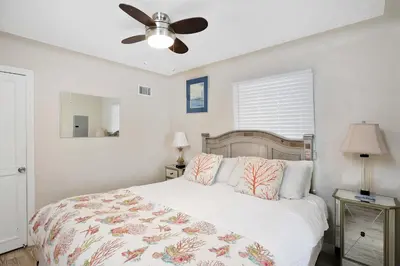 a bedroom with a bed and a ceiling fan at Grand Canal Getaway - Balboa Island in Newport Beach