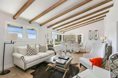 a living room with a couch and a table at Private Wading Pool Home with Patio in Corona del Mar