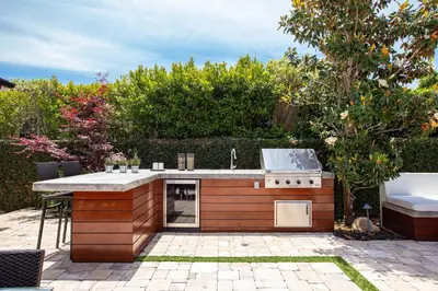 a outdoor kitchen with a counter in a backyard at Private Wading Pool Home with Patio in Corona del Mar