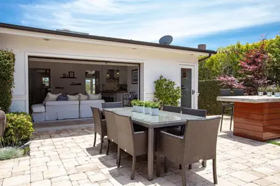 a patio with a table and chairs and a couch at Private Wading Pool Home with Patio in Corona del Mar
