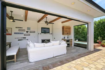 a living room with a white couch and sliding glass doors at Private Wading Pool Home with Patio in Corona del Mar