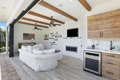 a living room with a white couch and a fireplace at Private Wading Pool Home with Patio in Corona del Mar