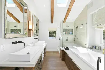 a bathroom with two sinks and a large tub at Private Wading Pool Home with Patio in Corona del Mar