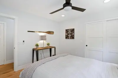 a bedroom with a bed and a ceiling fan at Private Wading Pool Home with Patio in Corona del Mar