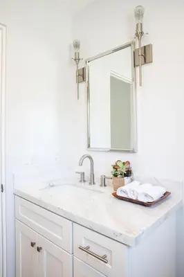a white bathroom with a sink and a mirror at A True Vacation Masterpiece in Corona del Mar