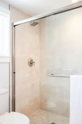 a bathroom with a glass shower with a toilet at A True Vacation Masterpiece in Corona del Mar
