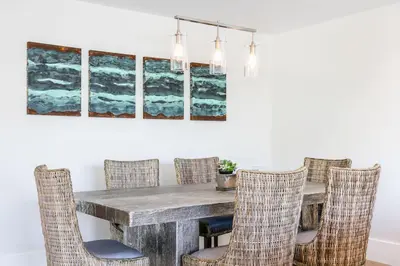 a dining room with a wooden table and chairs at A True Vacation Masterpiece in Corona del Mar