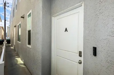 a white door with the letter a on a building at Newport Retreat A - Fab for 4 in Newport Beach