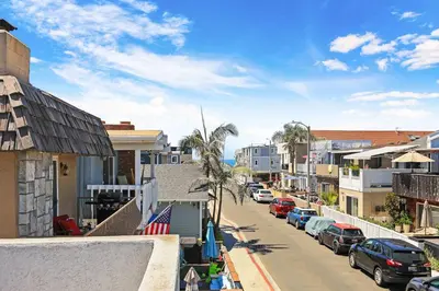 a city street with cars parked on the street at Newport Retreat B - Walk to Sandy Beaches in Newport Beach