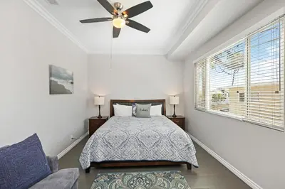 a bedroom with a bed and a ceiling fan at Newport Retreat B - Walk to Sandy Beaches in Newport Beach