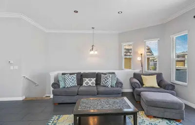 a living room with a couch and a table at Newport Retreat B - Walk to Sandy Beaches in Newport Beach