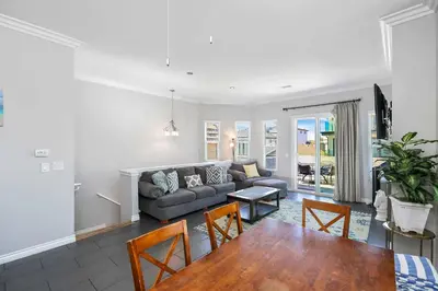 a living room with a couch and a table at Newport Retreat B - Walk to Sandy Beaches in Newport Beach