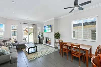 a living room with a couch and a table and a fireplace at Newport Retreat B - Walk to Sandy Beaches in Newport Beach