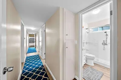 a corridor of a bathroom with a toilet at Ruby Villa A - Stay for 6 in Newport Beach