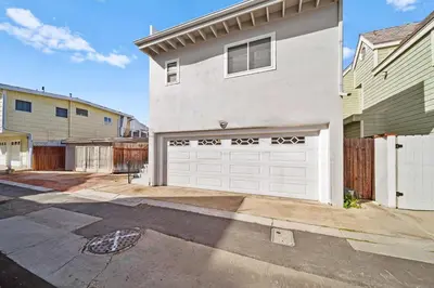 a white house with a white garage at Ruby Villa A - Stay for 6 in Newport Beach