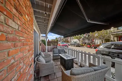 a patio with chairs and a table on a balcony at Ruby Villa A - Stay for 6 in Newport Beach