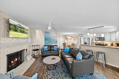 a living room with a couch and a fireplace at Ruby Villa A - Stay for 6 in Newport Beach