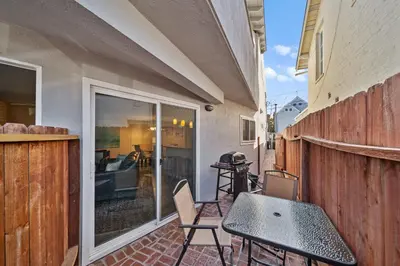 a patio with a table and chairs on a balcony at Ruby Villa A - Stay for 6 in Newport Beach