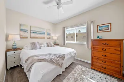 a bedroom with a bed and a dresser and a window at Ruby Villa B - Upper Unit for 6 in Newport Beach