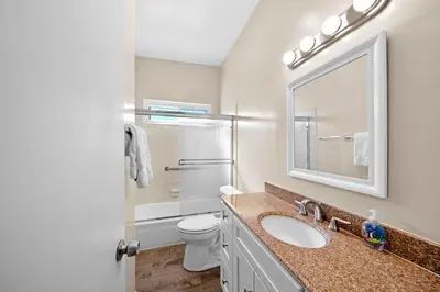 a bathroom with a sink and a toilet and a mirror at Ruby Villa B - Upper Unit for 6 in Newport Beach