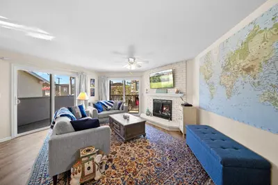 a living room with a couch and a map on the wall at Ruby Villa B - Upper Unit for 6 in Newport Beach