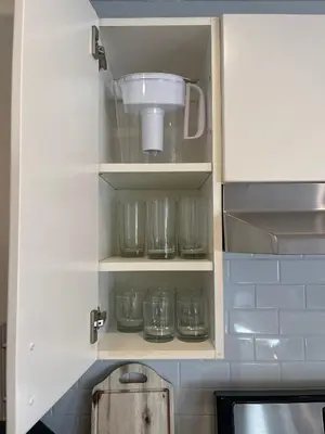 a kitchen cupboard with glass jars and a blender at Bright & Quiet 1-Bed Condo with Balcony in San Diego