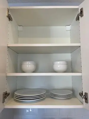 a kitchen with white plates and bowls on shelves at Bright & Quiet 1-Bed Condo with Balcony in San Diego