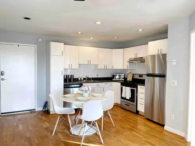 a kitchen with a table and chairs and a refrigerator at Bright & Quiet 1-Bed Condo with Balcony in San Diego