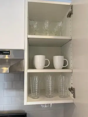 a kitchen cupboard with cups and glasses in it at Bright & Quiet 1-Bed Condo with Balcony in San Diego