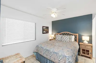 a bedroom with a bed and a ceiling fan at Seashore Sun and Fun - On Beach in Newport Beach