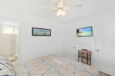 a bedroom with a bed and a ceiling fan at Seashore Sun and Fun - On Beach in Newport Beach